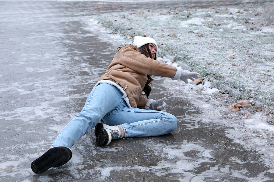 Woman is injured in a public slip and fall accident on an icy sidewalk