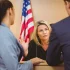 Judge talks to two lawyers in a courtroom